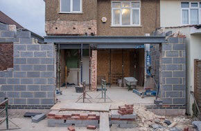 Single-storey house extension under construction with new brickwork