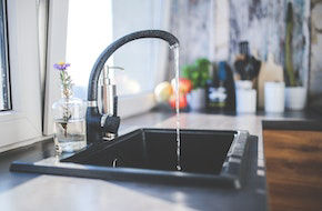 New stainless steel kitchen sink and mixer tap fitted into a worktop